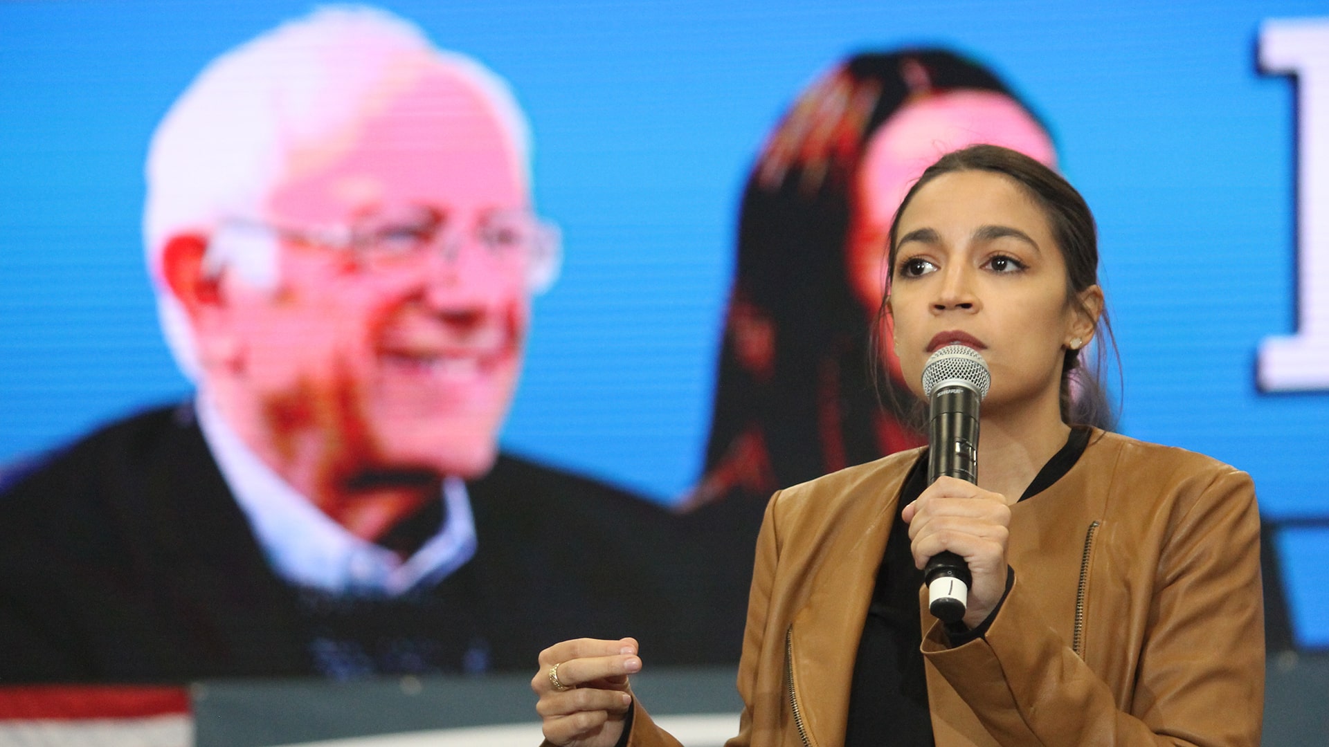 Rep. Alexandria Ocasio-Cortez speaking to attendees at a rally for Bernie Sanders in Council Bluffs, Iowa. Please attribute to Matt A.J. if used elsewhere. Matt Johnson via Wiki Commons.
